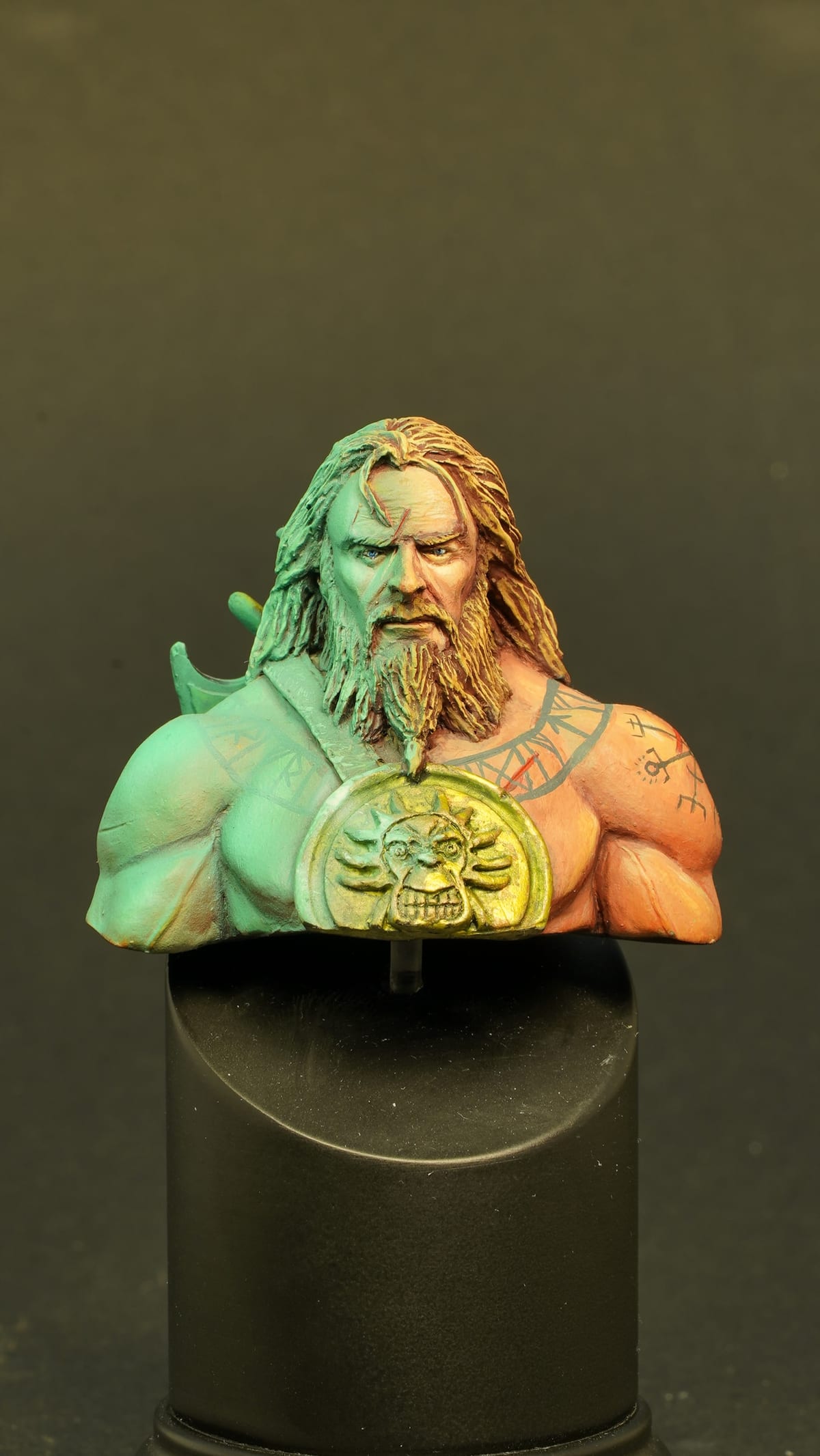 Bust of a bearded man with a gold medallion, painted in turquoise and warm tones