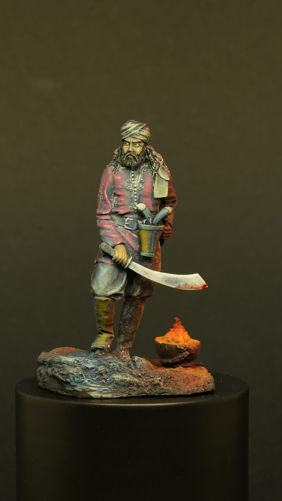 A man with a curved sword next to a burning brazier