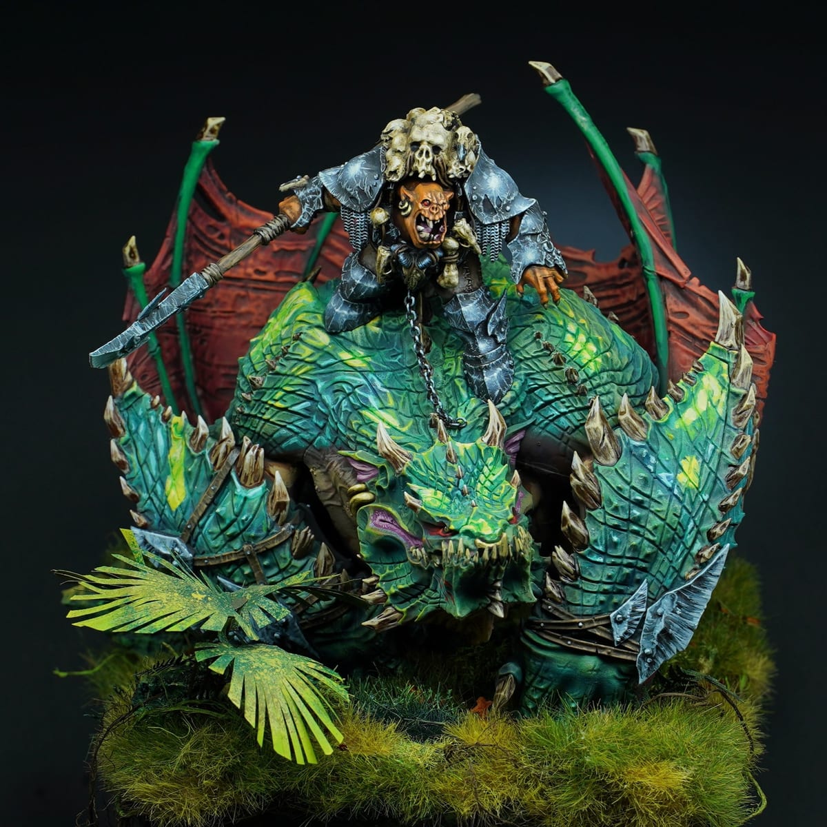 Gordrakk on his maw-krusha, green scales and jungle base on a black background