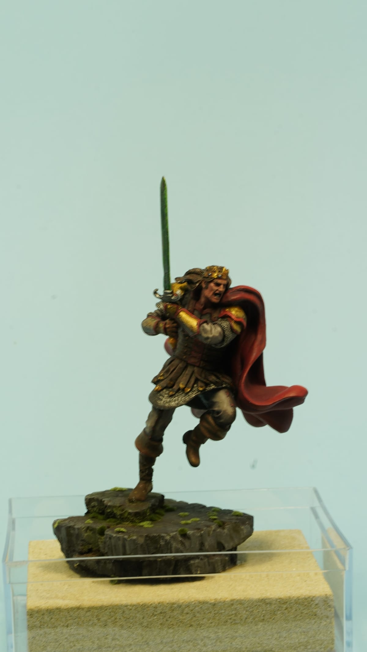A warrior leaping forward with a long sword, his red cloak flying